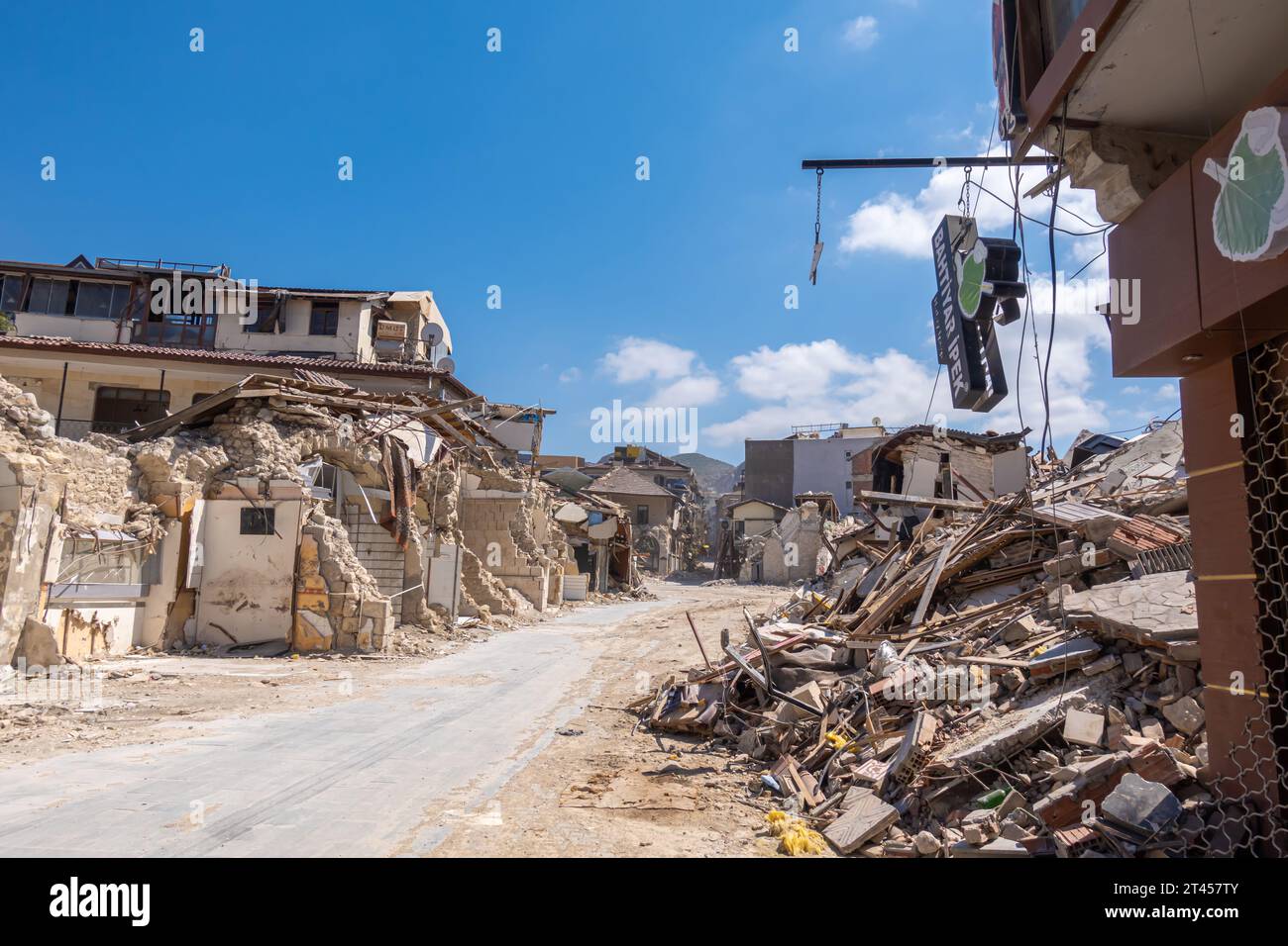 Hanging sign Bahtiyar İpek, destroyed buildings in the central Antakya Hatay Turkey Stock Photo