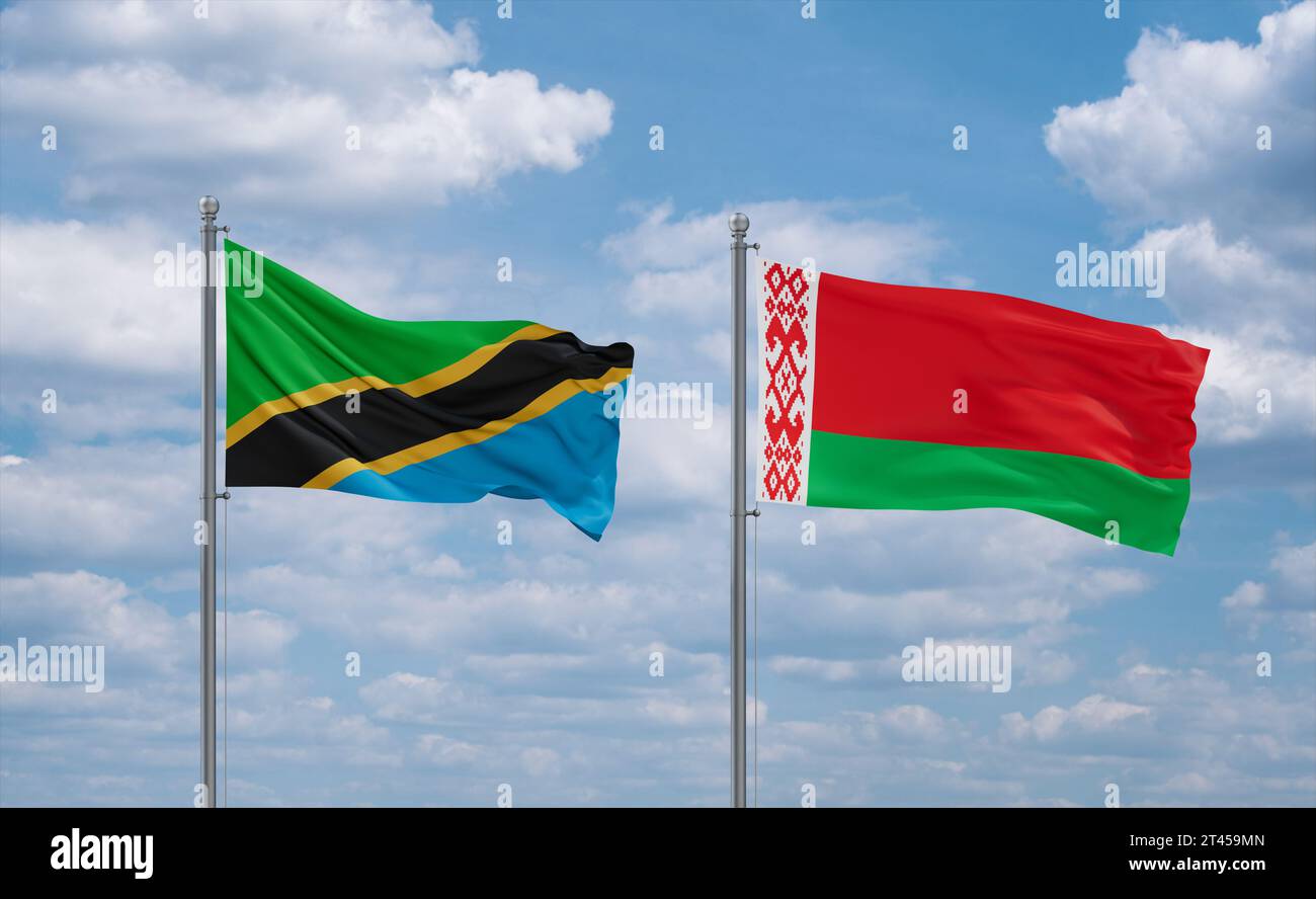 Belarus and Tanzania flags waving together in the wind on blue cloudy ...