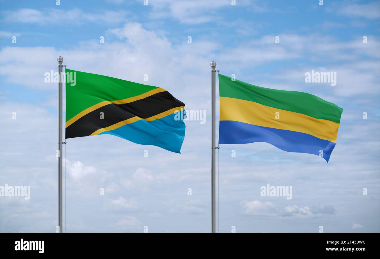 Gabon and Tanzania flags waving together on blue cloudy sky, two ...