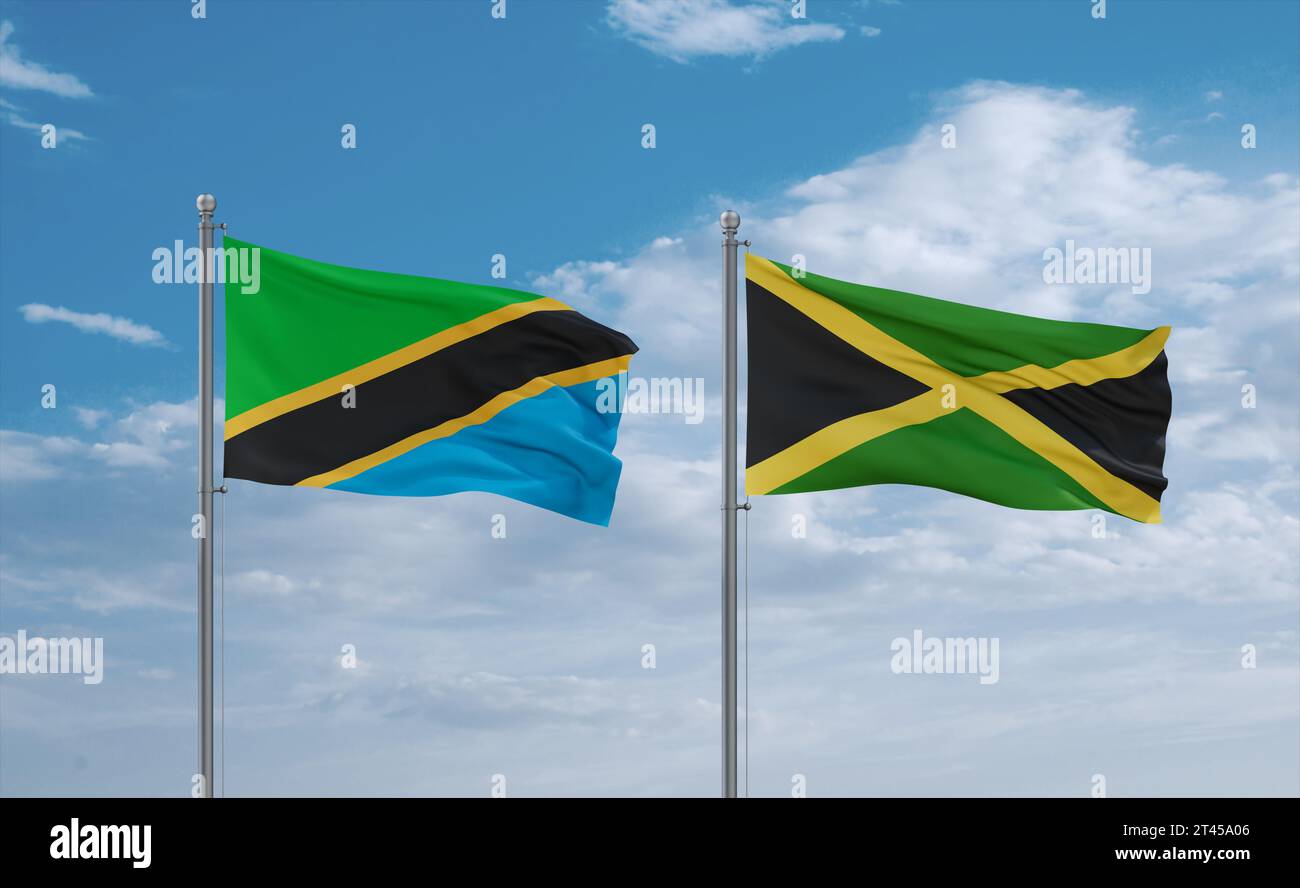 Jamaica and Tanzania flags waving together in the wind on blue cloudy ...