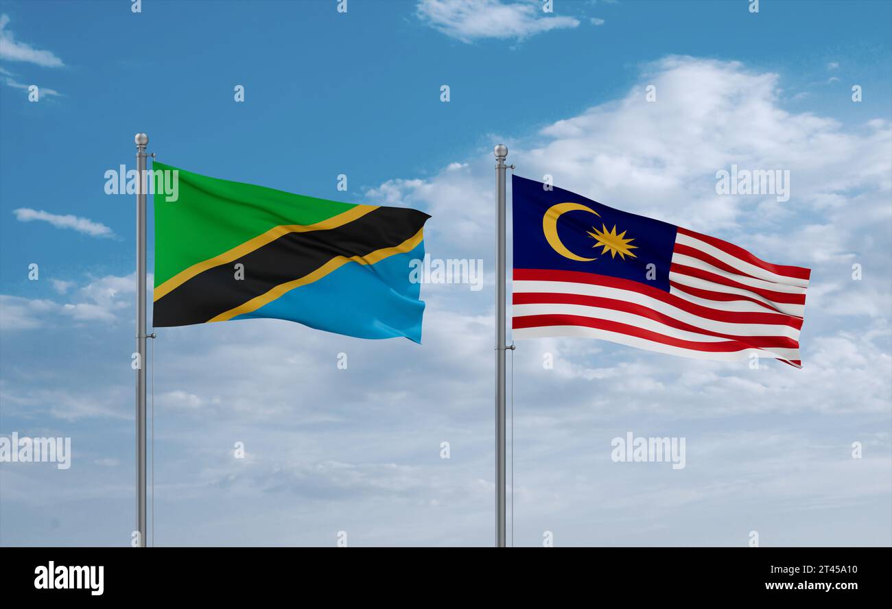 Malaysia and Tanzania flags waving together in the wind on blue cloudy ...