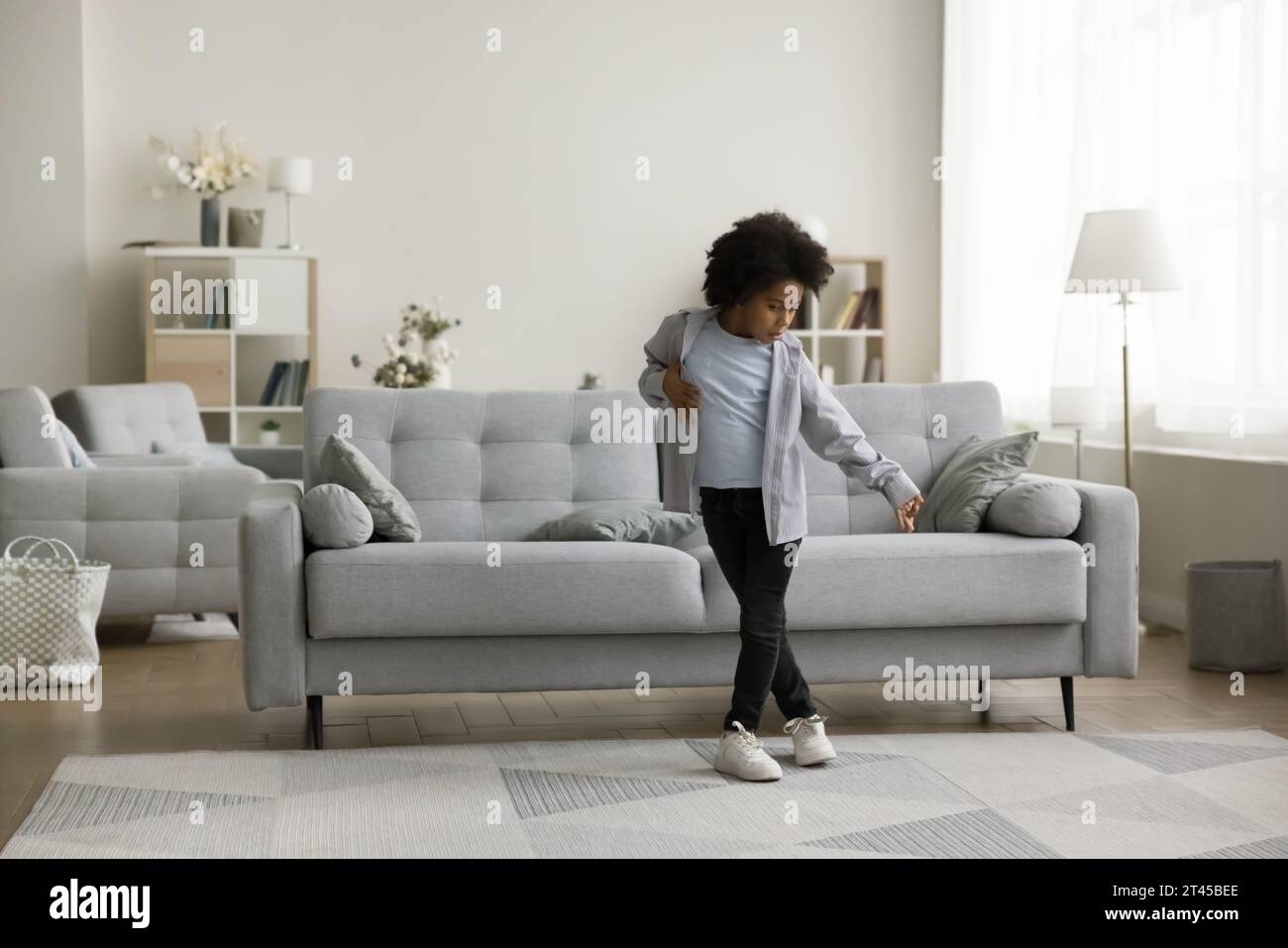Pretty little African boy dancing in living room Stock Photo Alamy