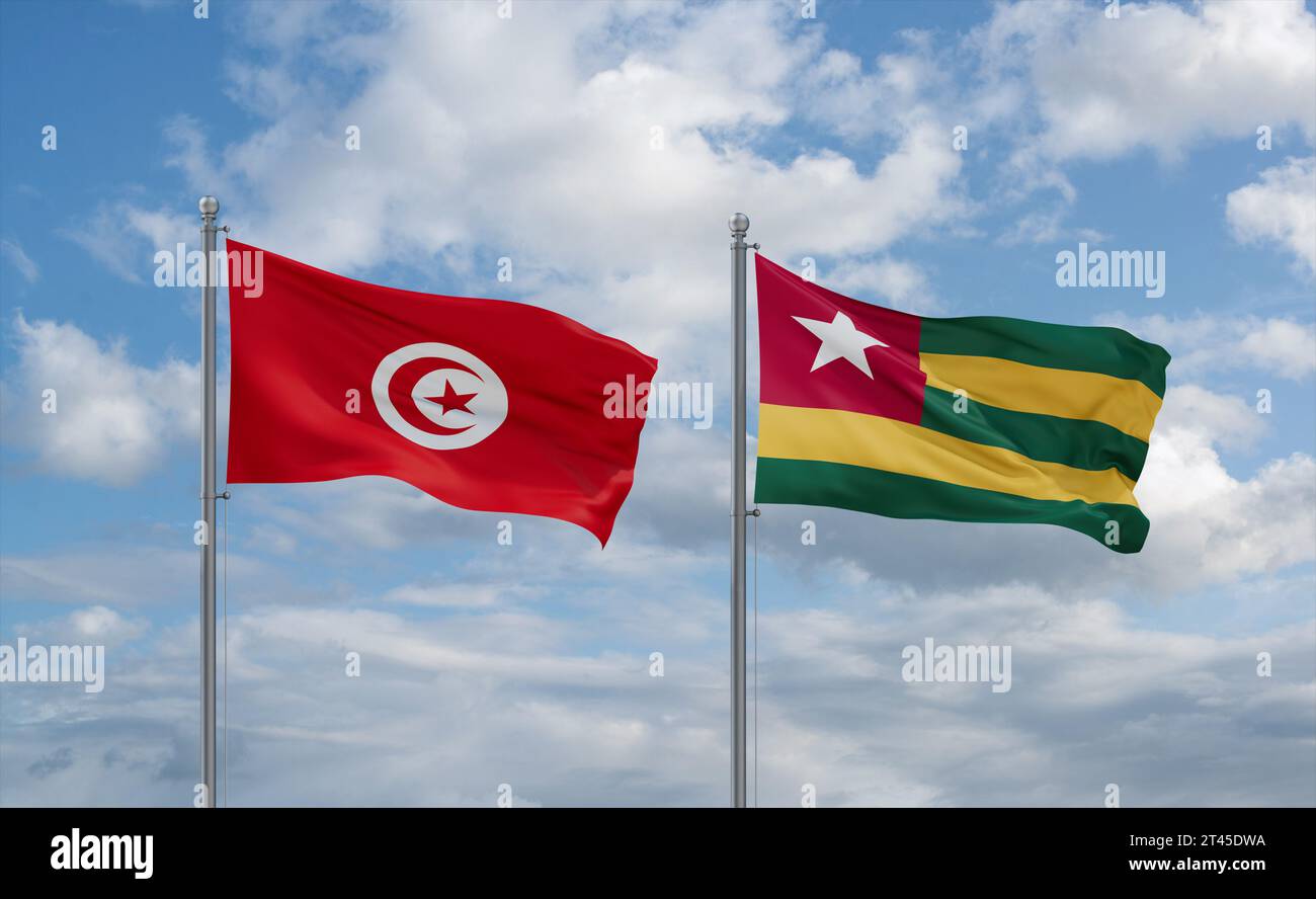 Togo, Togolese Republic and Tunisia flags waving together in the wind on blue cloudy sky, two country relationship concept Stock Photo