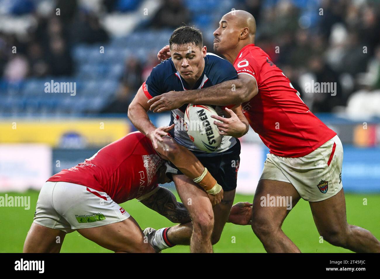 Jack Welsby of England spills the ball as he is tackled by Tyson ...