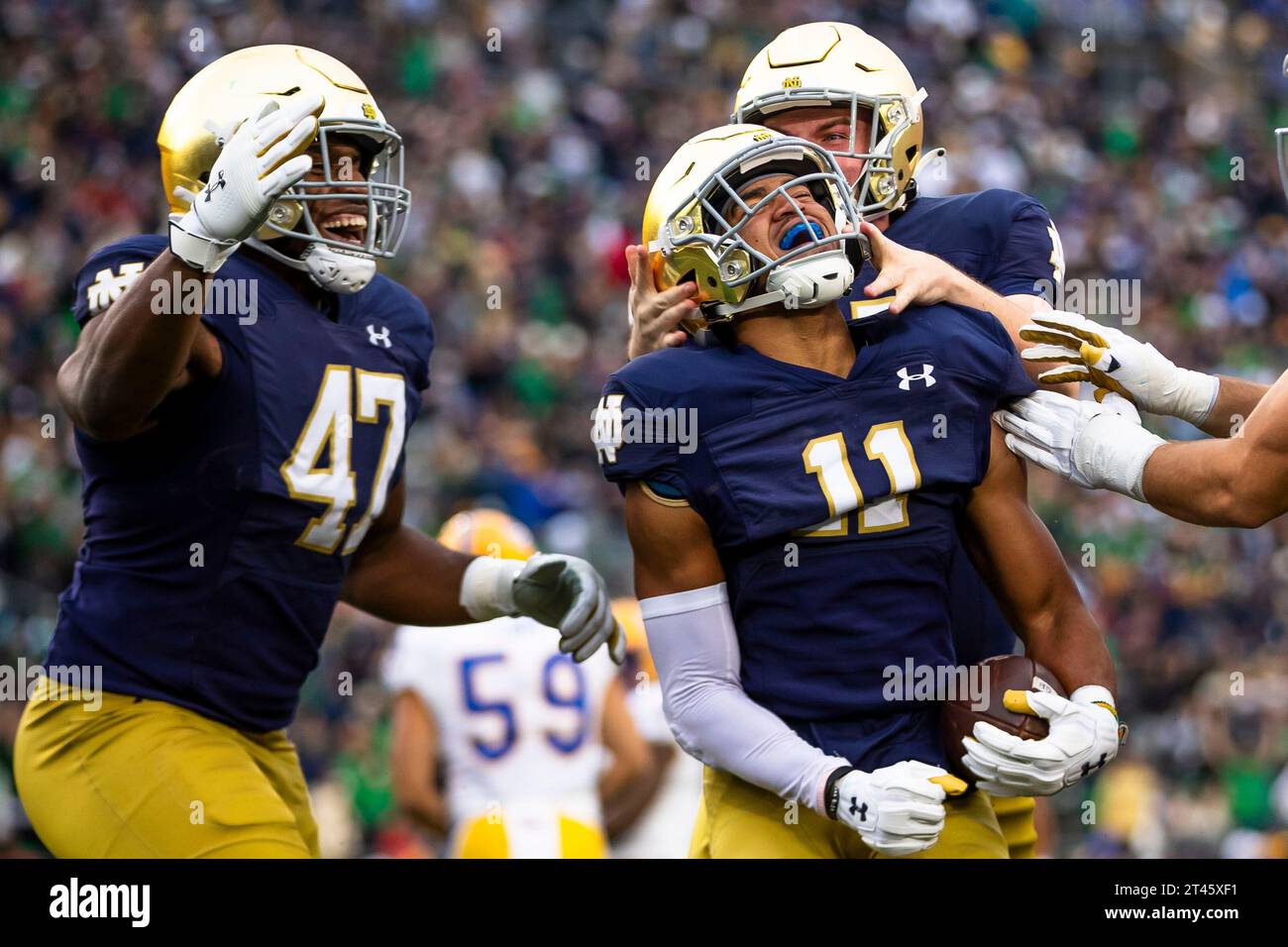 Michael Snapper Notre Dame defensive lineman Jason Onye (47) and long snapper Michael ...