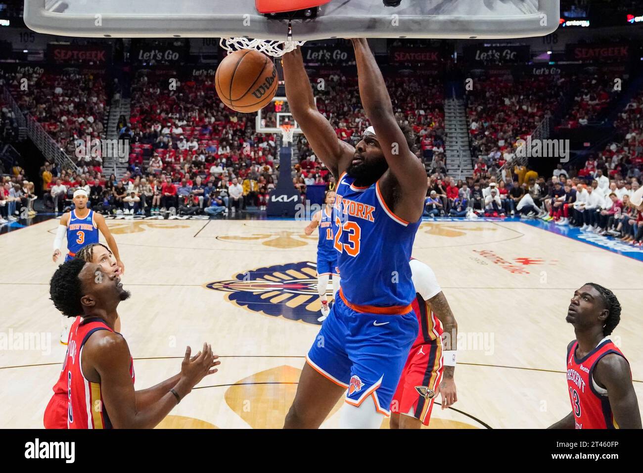 New York Knicks center Mitchell Robinson (23) slam dunks between New