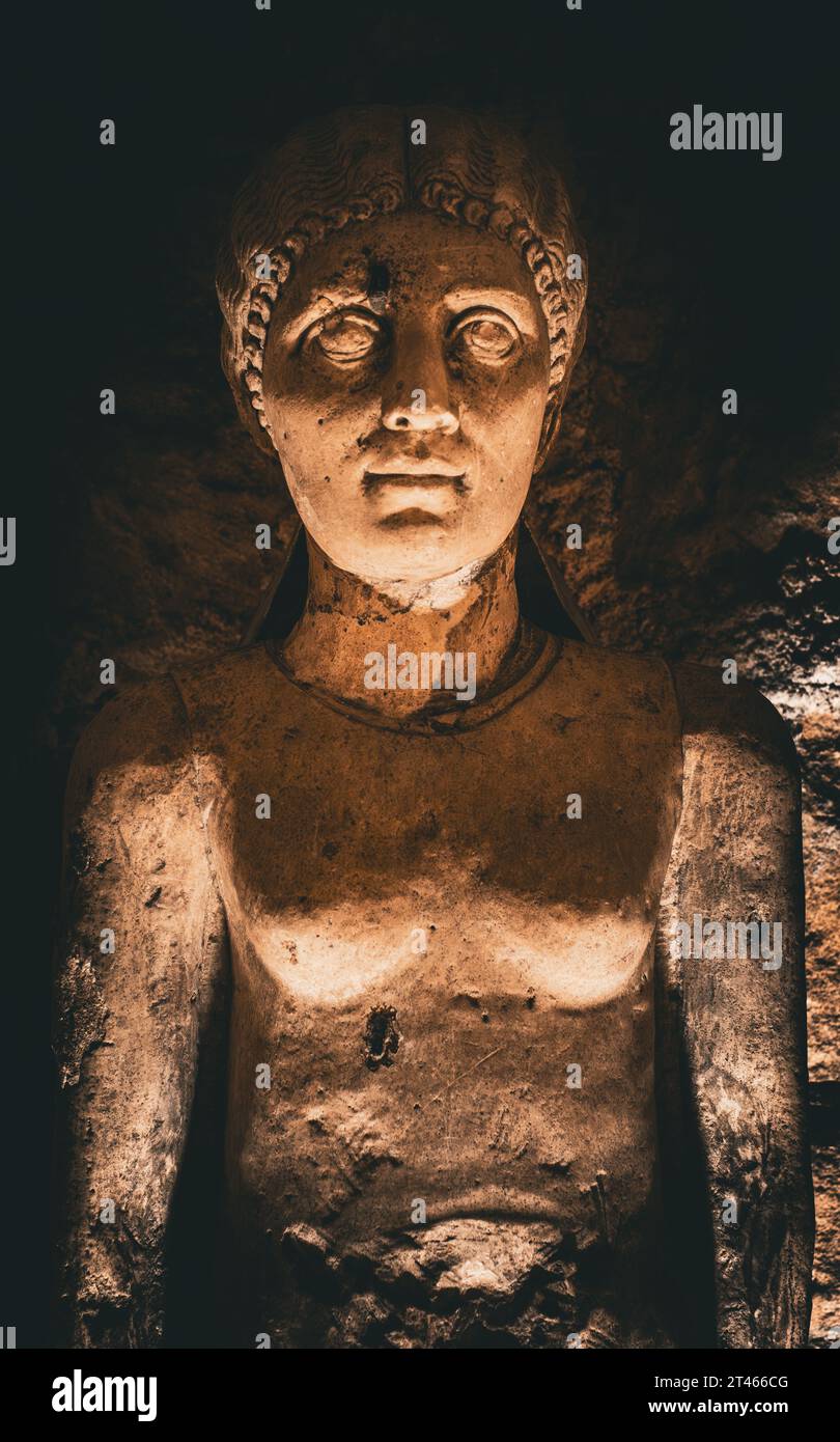 An intricately carved stone statue inside the Catacombs of Alexandria Stock Photo