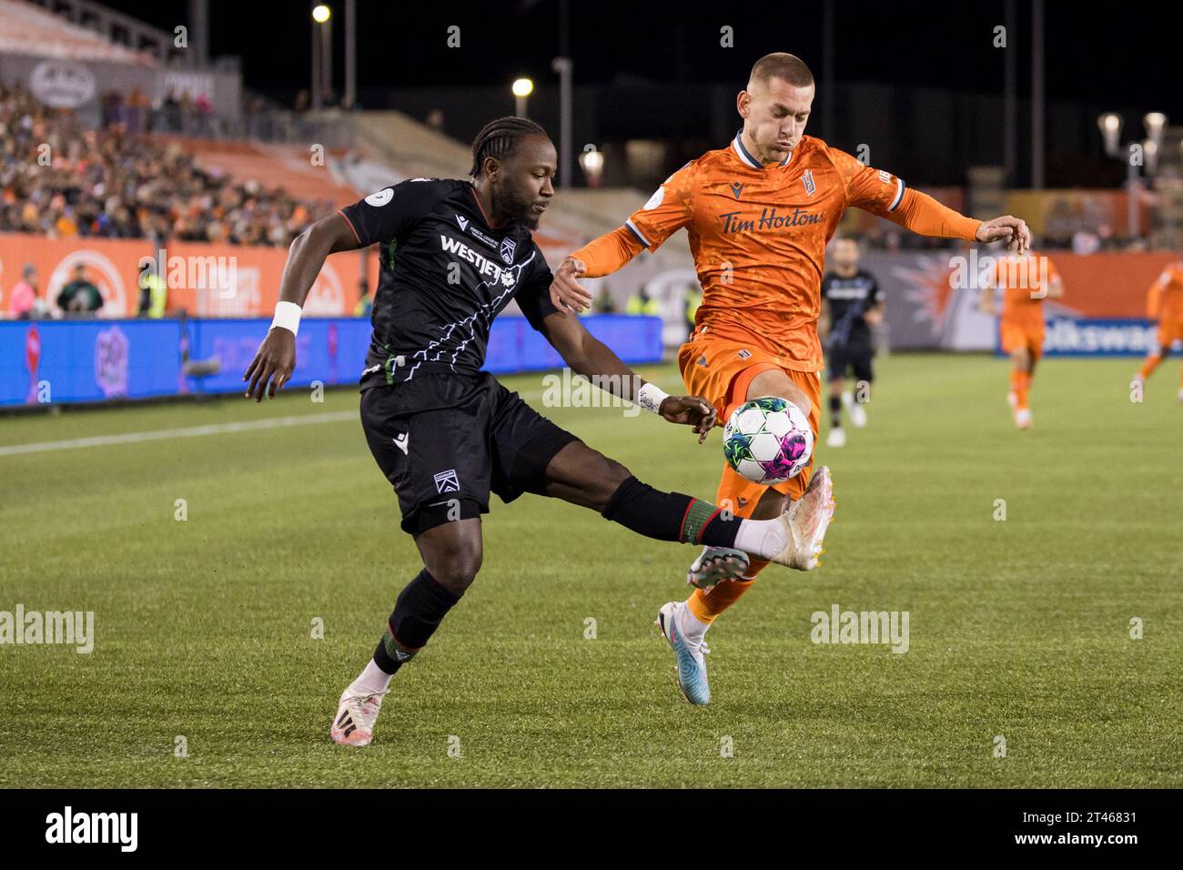 Forge FC defender Rezart Rama, right, fights for the ball with Cavalry ...