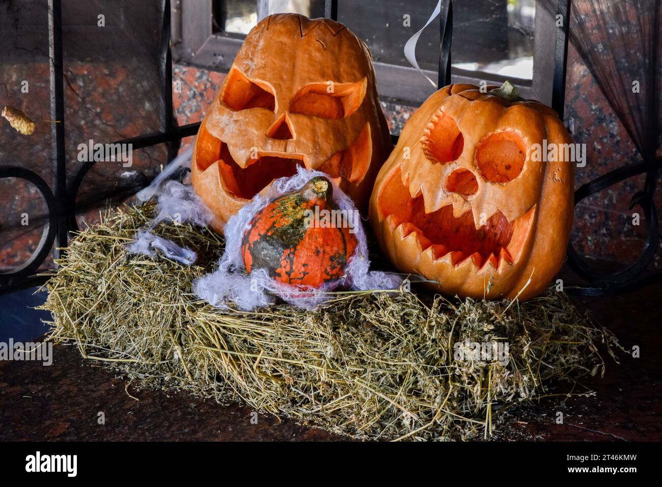 Halloween decorations are seen placed at the café entrance in Zaporizhzhia. Halloween of Celtic origin came to Ukraine after the collapse of the Soviet Union. From that time the Ukrainians took over the tradition from other countries to dress in creepy costumes, to cut out the main attribute of this holiday - the pumpkin and to collect the candies among the neighbors. The modern Orthodox Church is still condemning this holiday, but every year in Ukraine are more and more young people who aren't against “going to the side of the evil” for one night. Stock Photo
