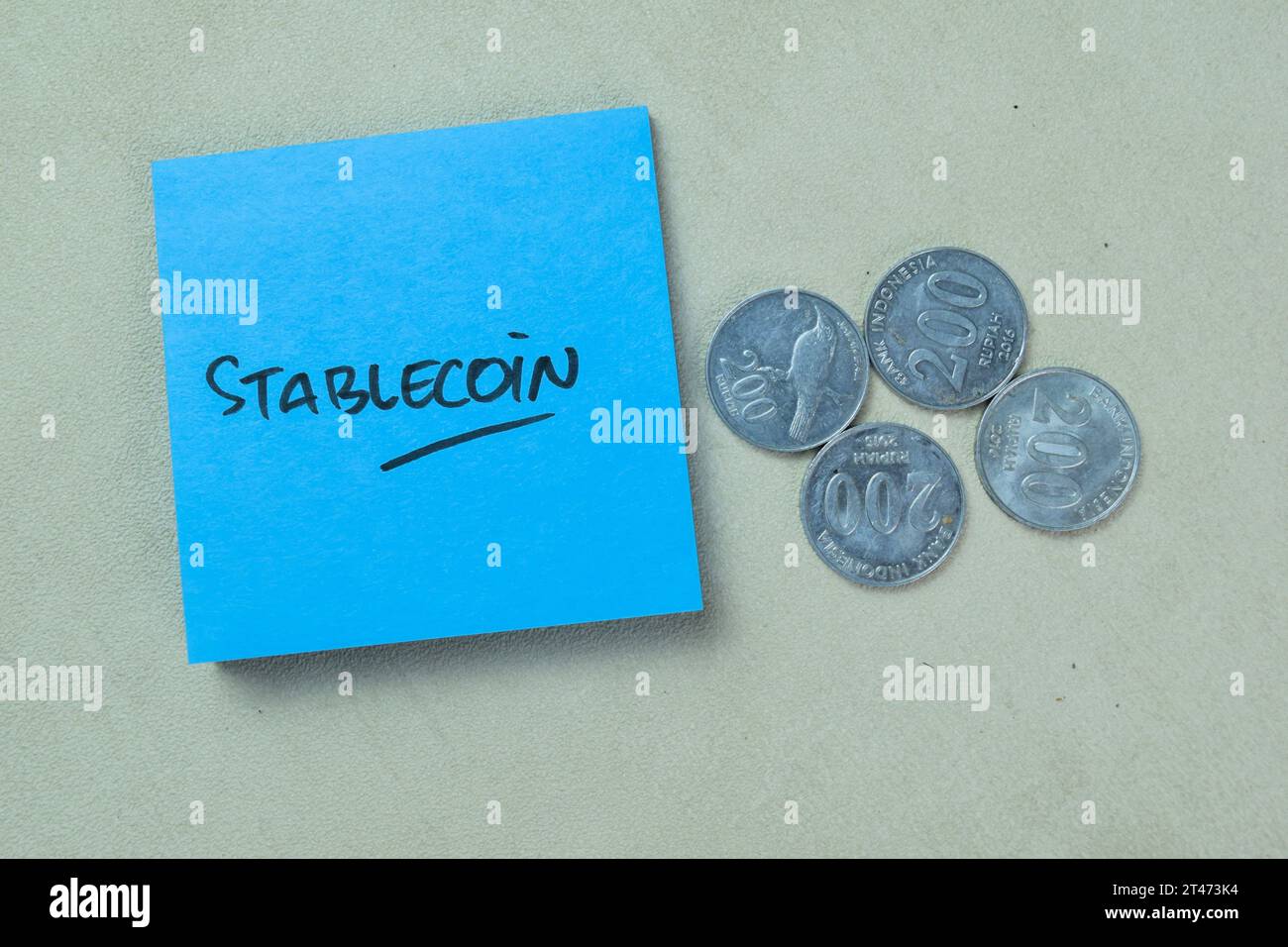 Concept of Stablecoin write on sticky notes with Indonesian Currency isolated on Wooden Table. Stock Photo
