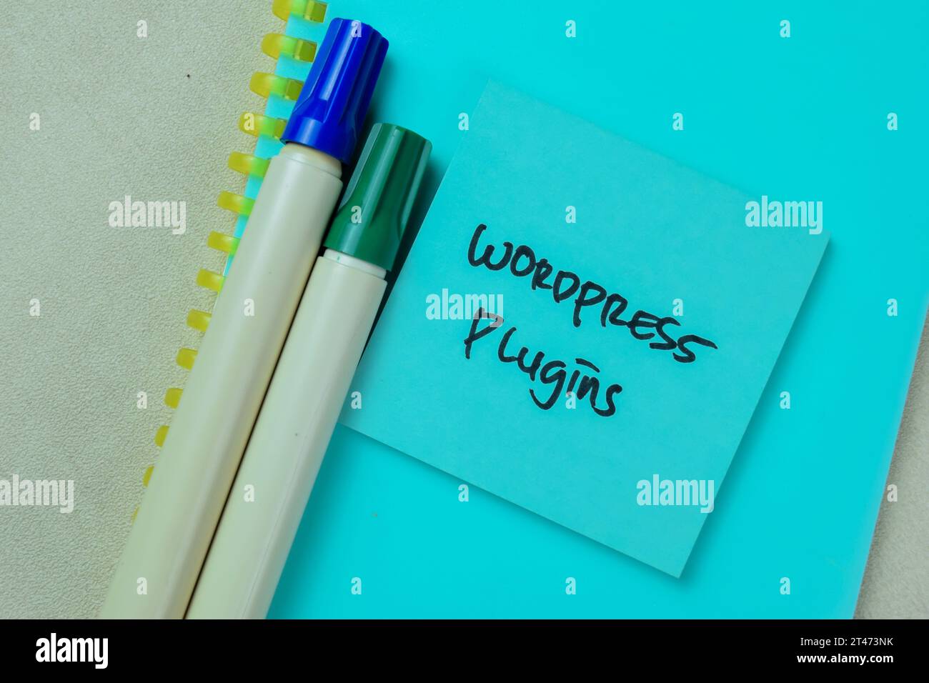 Concept of Wordpress Plugin write on sticky notes isolated on Wooden Table. Stock Photo
