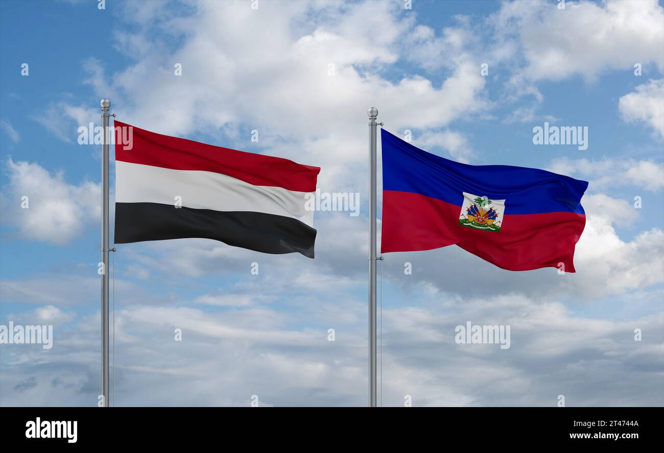 Haiti and Yemen flags waving together on blue cloudy sky, two country relationship concept Stock Photo