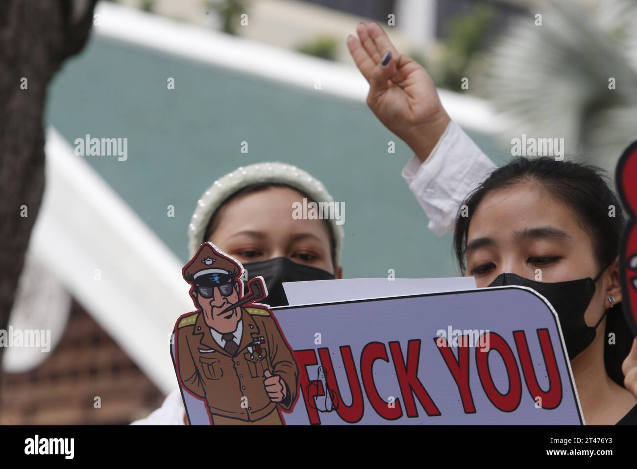 Bangkok, Thailand. 29th Oct, 2023. (EDITOR'S NOTE: Image depicts profanity) Myanmar nationals living in Thailand flash the three-finger salute and holds placards during a protest on campaign 1000 days since coup in Myanmar in front of United Nations building. The Myanmar military seized power in February 2021. (Photo by Chaiwat Subprasom/SOPA Images/Sipa USA) Credit: Sipa USA/Alamy Live News Stock Photo