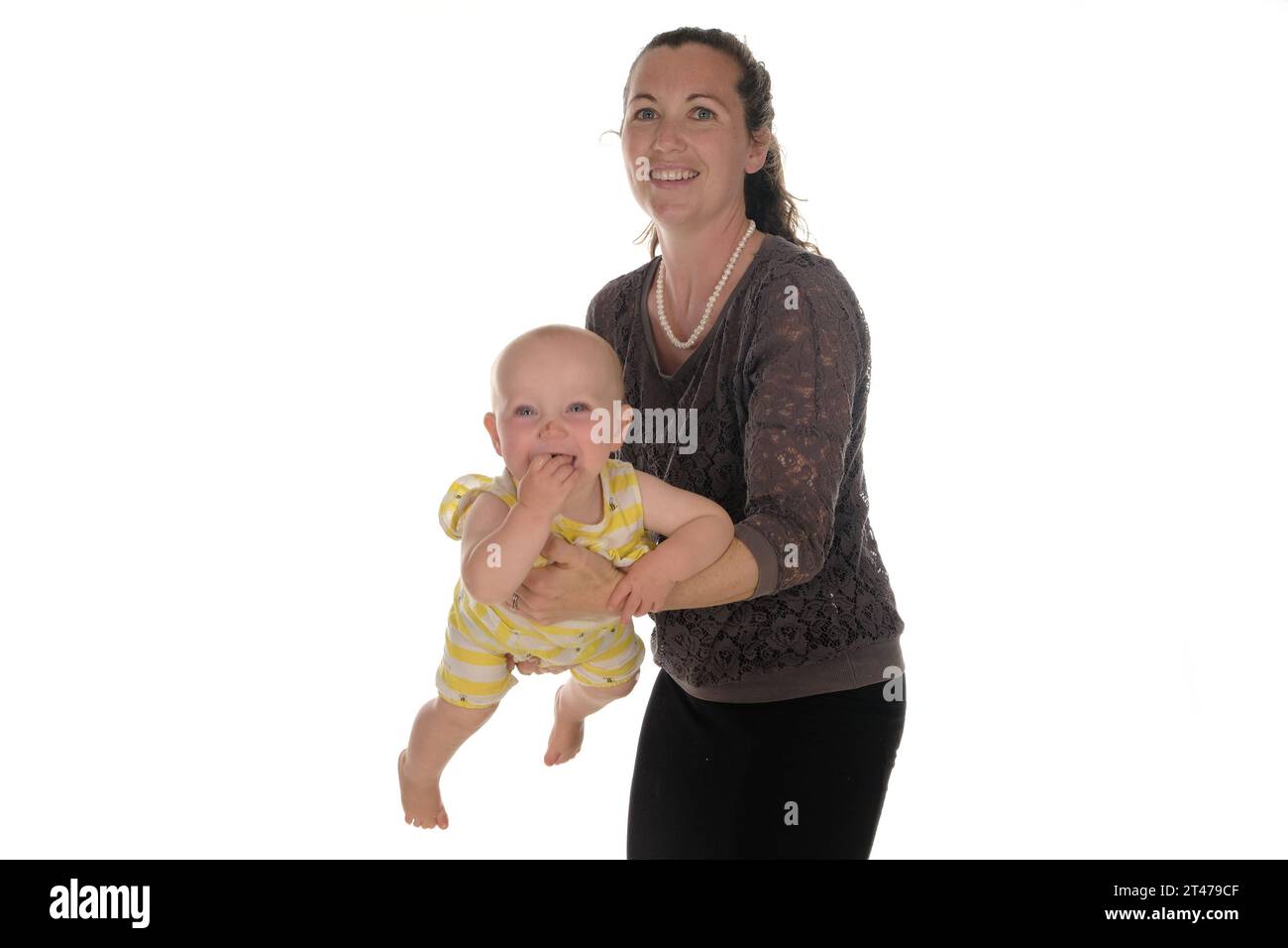 Mother and baby happy standing swinging in arms Stock Photo Alamy