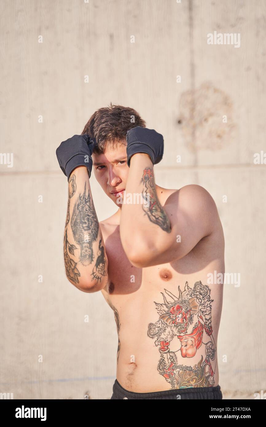 athlete with cubes on his stomach press pumped up torso muscles tattoos  nude view 23668190 Stock Photo at Vecteezy