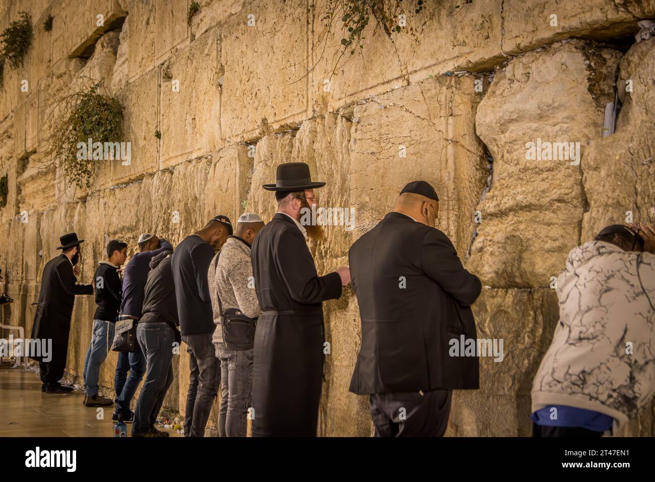 The religious Jewish people praying at Western wall (Wailing Wall), the Jewish shrine, at Jerusalem Old Town in Israel. Stock Photo