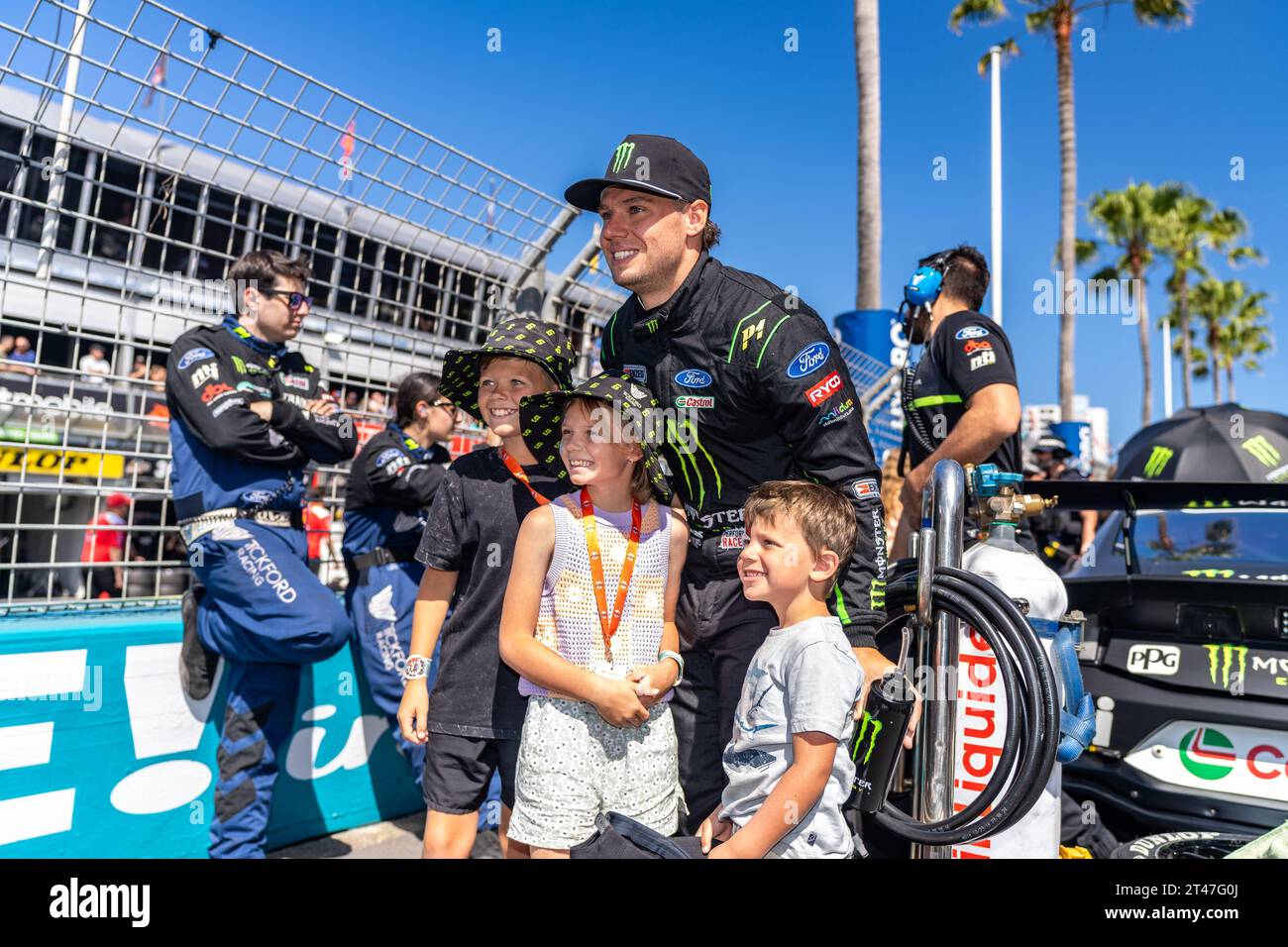 Gold Coast, Australia. 29 October, 2023. Tickford Racing's Cam Waters poses for a photo with some of the VIP guests children on the grid at the Boost Mobile Gold Goast 500. Credit: James Forrester/Alamy Live News Stock Photo