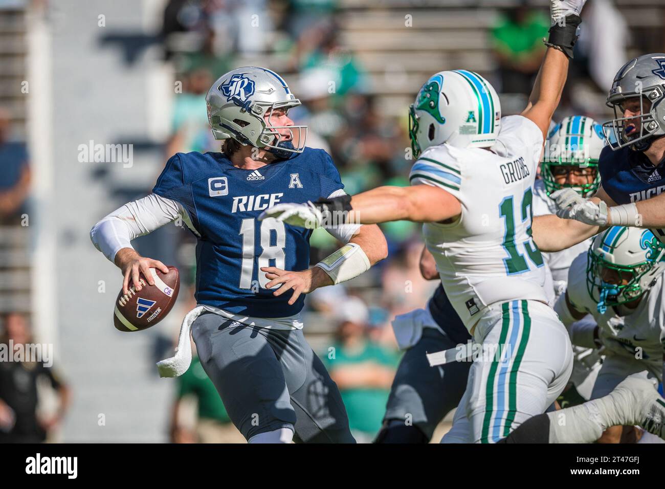 Houston, Texas, USA. 28th Oct, 2023. Rice Owls quarterback JT Daniels (18) is pressured by Tulane Green Wave line backer Tyler Grubbs (13) during the NCAA football game between the Tulane Green Wave and the Rice Owls at Rice Stadium in Houston, Texas. Tulane defeated Rice 30-28. Prentice C. James/CSM/Alamy Live News Stock Photo
