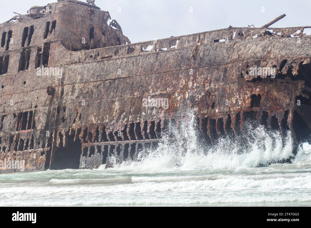 image of an old ship full of rust abandoned to its fate listing on a ...