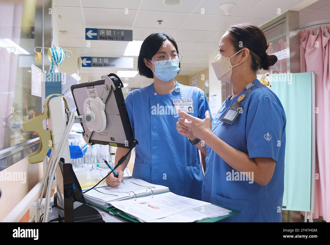 Hong Kong. 18th Oct, 2023. Liu Jiali (L) and Savina Sze work in a ward at Prince of Wales Hospital in south China's Hong Kong, Oct. 18, 2023. TO GO WITH 'Feature: Hong Kong, mainland healthcare professionals exchange brings mutual inspiration' Credit: Chen Duo/Xinhua/Alamy Live News Stock Photo