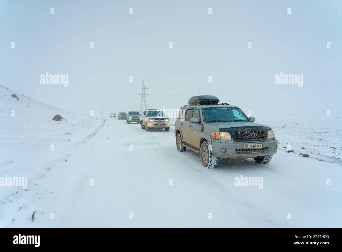 jeep journey in the snow of Kyrgyzstan Stock Photo