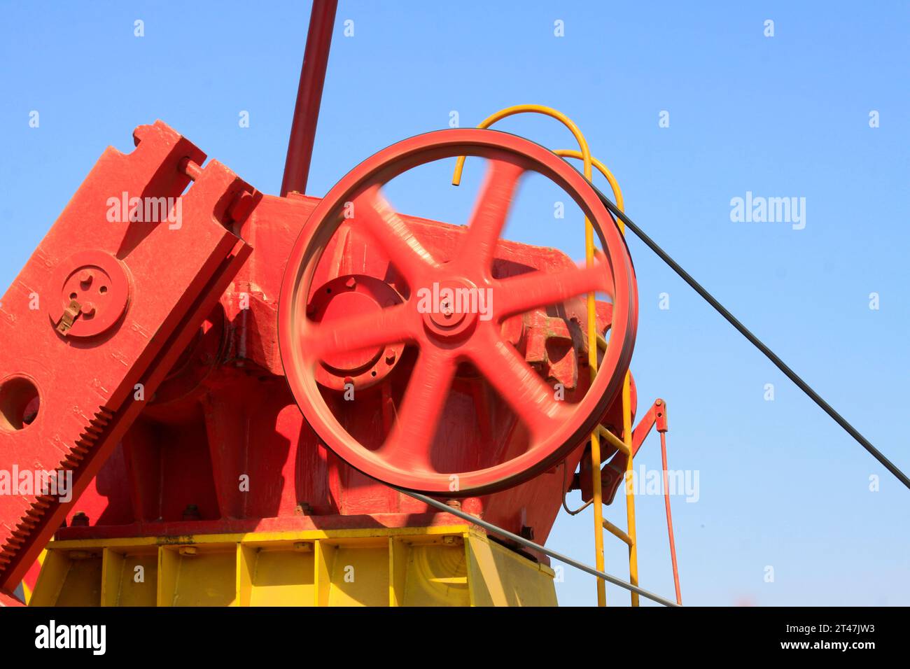 Beam pumping unit rotating wheels, closeup of photo Stock Photo