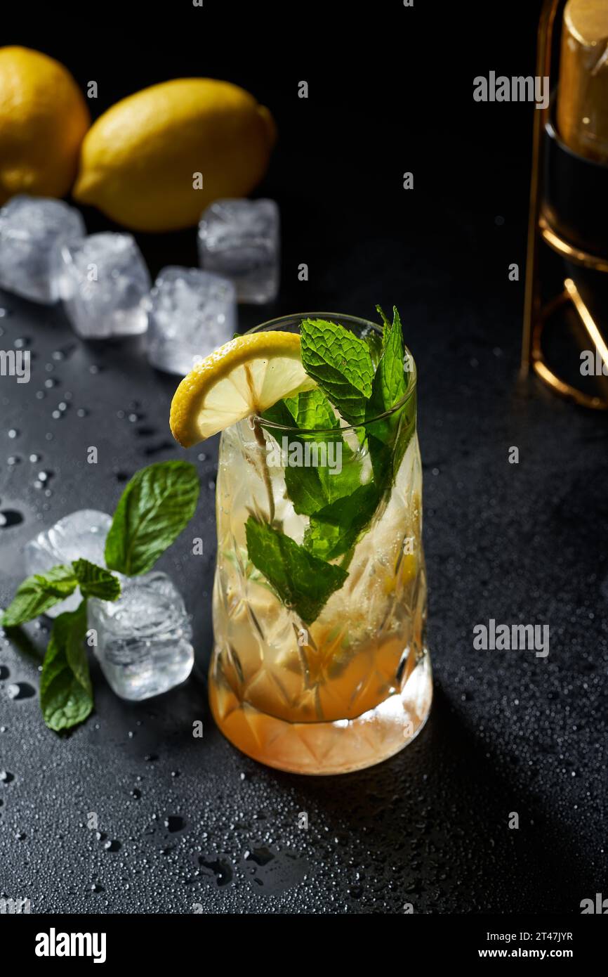 Images of a glass of soda and lemon cocktail with salt on a black background Stock Photo