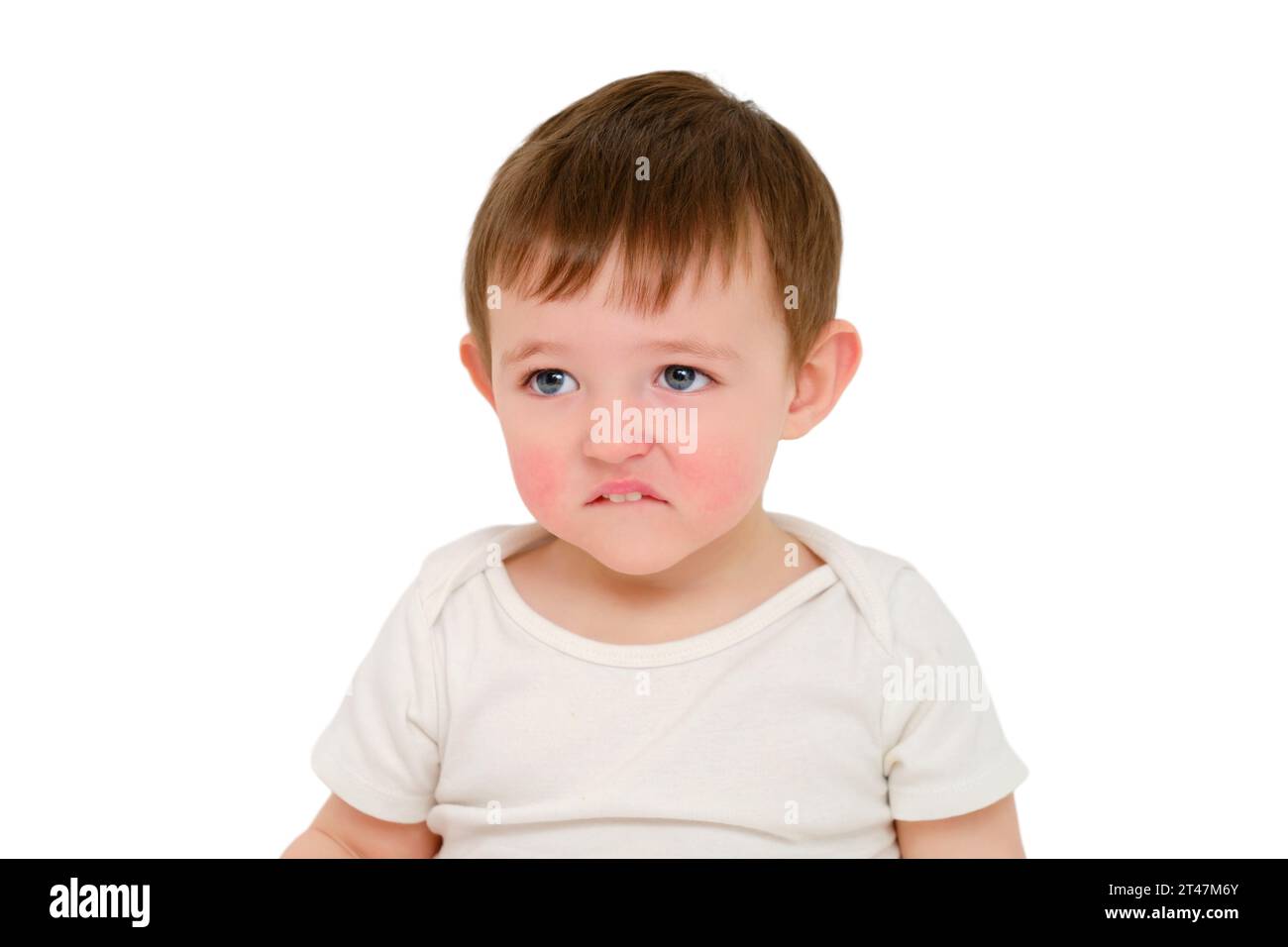 Offended baby looks pursed lips, studio, isolated on white background