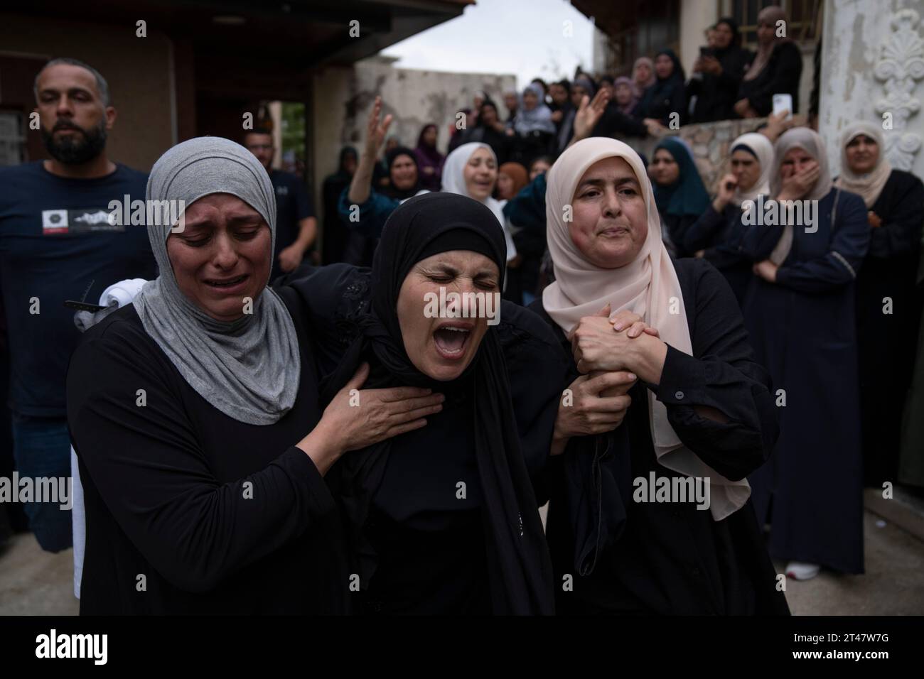 Palestinians mourn Nasser Barghouti during his funeral in the West Bank ...