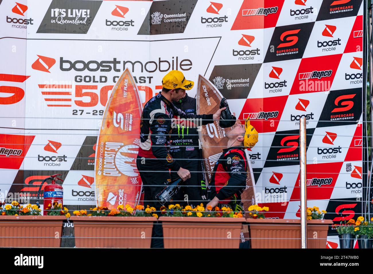 Gold Coast, Australia. 29 October, 2023. Grove Racing's David Reynolds gives his team principle a ‘shoey’ after winning Race 26 at the Boost Mobile Gold Goast 500. Credit: James Forrester/Alamy Live News Stock Photo