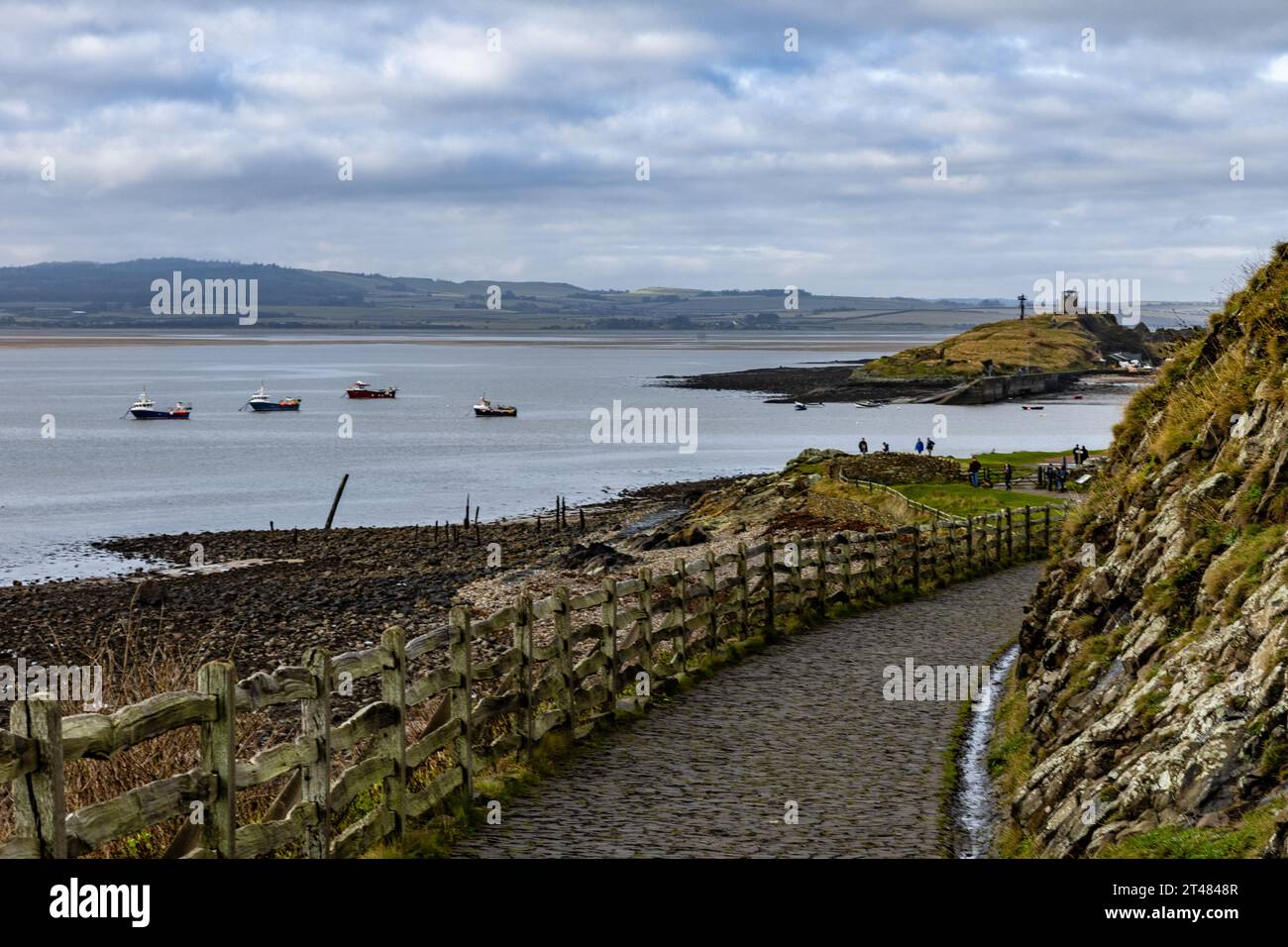 Holy Isle, United Kingdom. 28 October, 2023 Pictured: A cobbled pathway under Lindisfarne Castle leading to Holy Isle Harbour in Northumberland. Credi Stock Photo