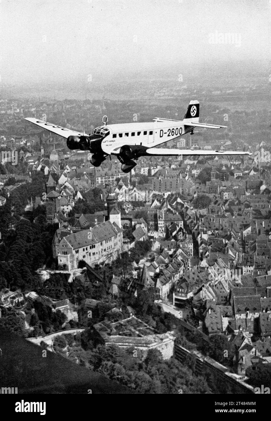 ADOLF HITLER flies over Nuremburg / Nurnberg in his first private aeroplane Junker JU 52/3m registration number D-2600 as he arrives for the 1934 6th Nazi Party Congress on 5th September as seen in TRIUMPH DES WILLENS / TRIUMPH OF THE WILL 1935 director / producer / editor / co-writer LENI RIEFENSTAHL music Herbert Windt Leni Riefenstahl-Produktion / Reichspropagandaleitung / Universum Film (UFA) Stock Photo
