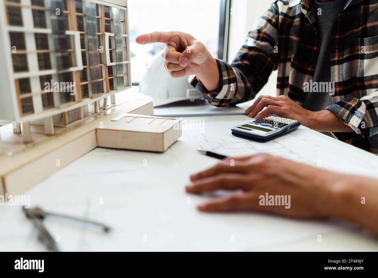 Two engineer discussion and brainstorming about condominium model of ...