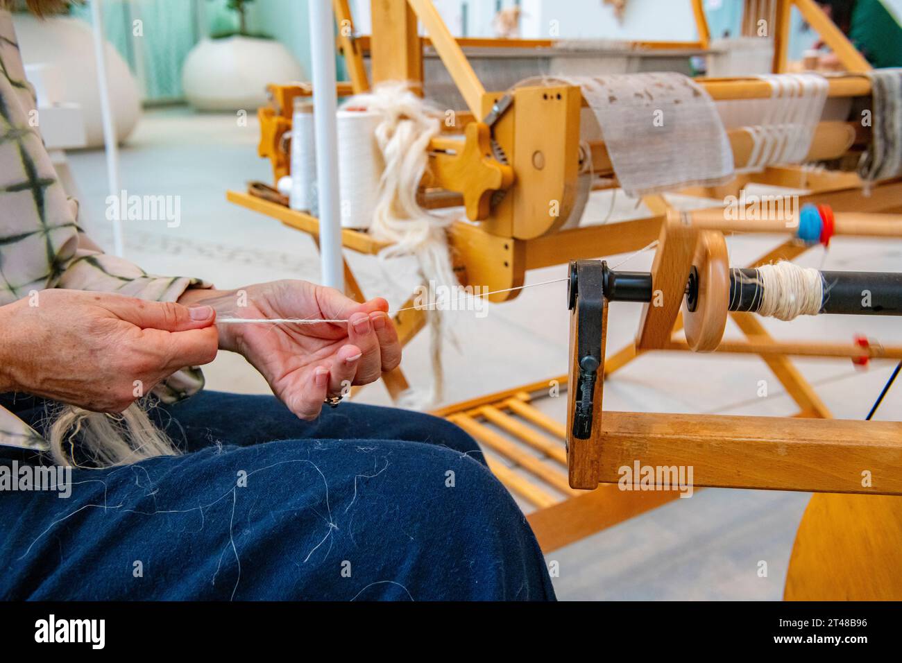 Spinning hemp with a traditional loom Stock Photo