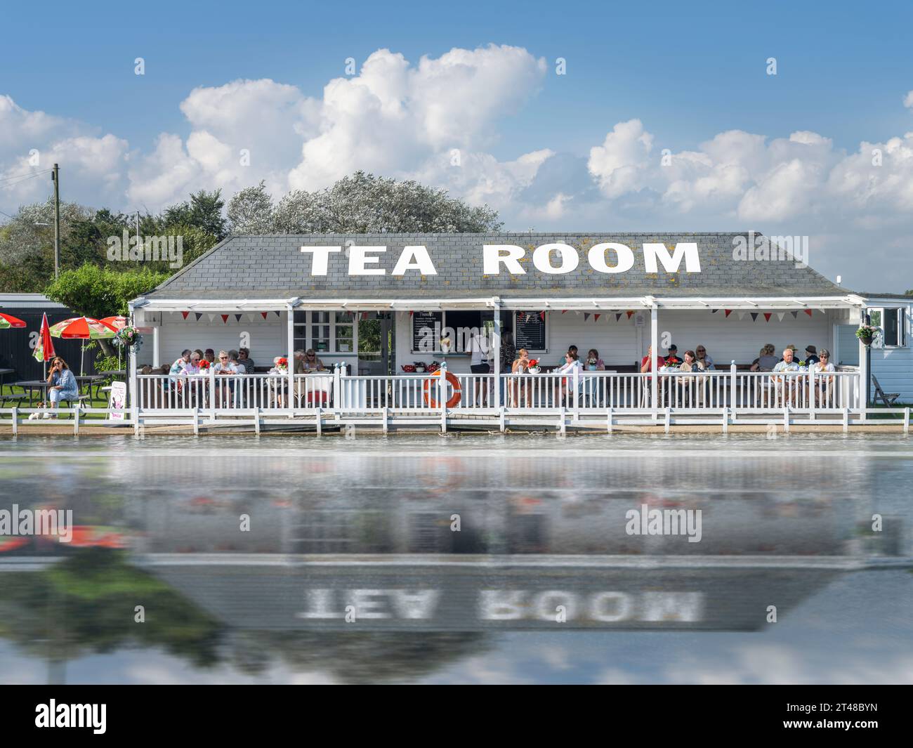 The popular seaside Tea Room is reflected in the boating lake in the holiday resort of Southwold in Suffolk, England. Stock Photo