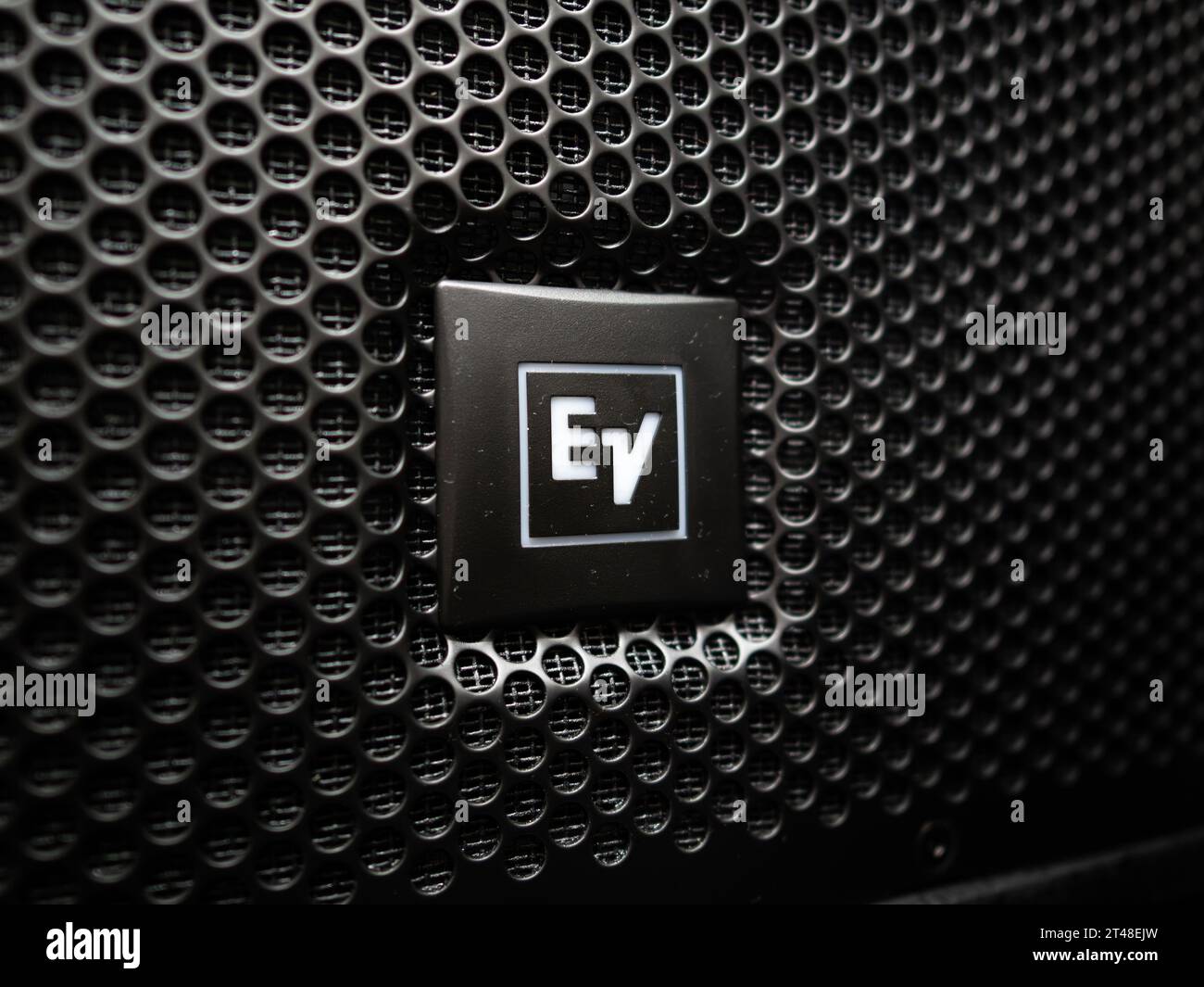 EV (Electro Voice) logo sign on a PA speaker in close up. The loudspeaker brand manufactures