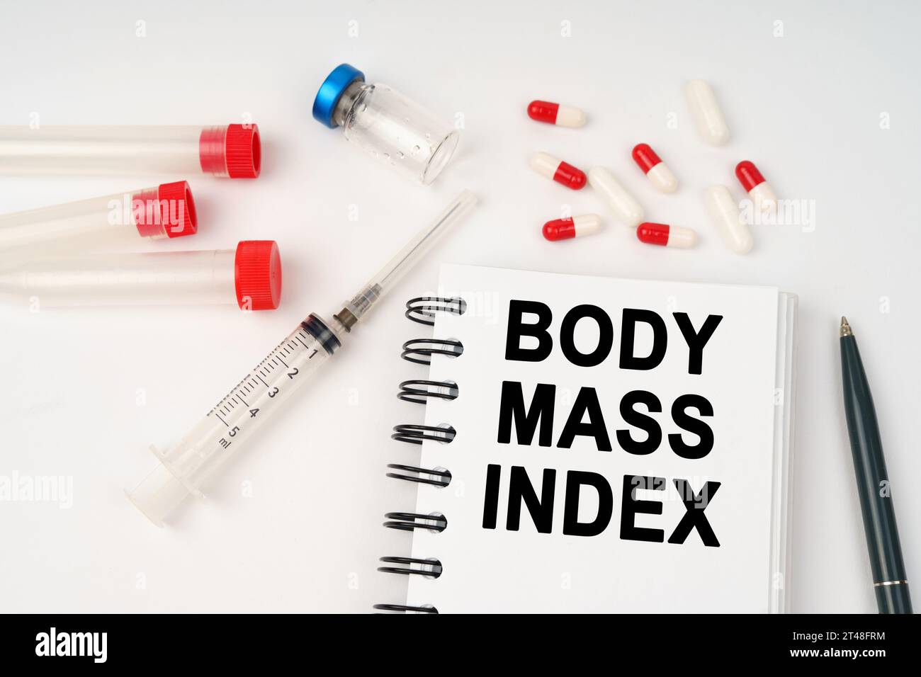 https://c8.alamy.com/comp/2T48FRM/medical-concept-on-the-table-are-pills-injections-a-syringe-and-a-notepad-with-the-inscription-body-mass-index-2T48FRM.jpg