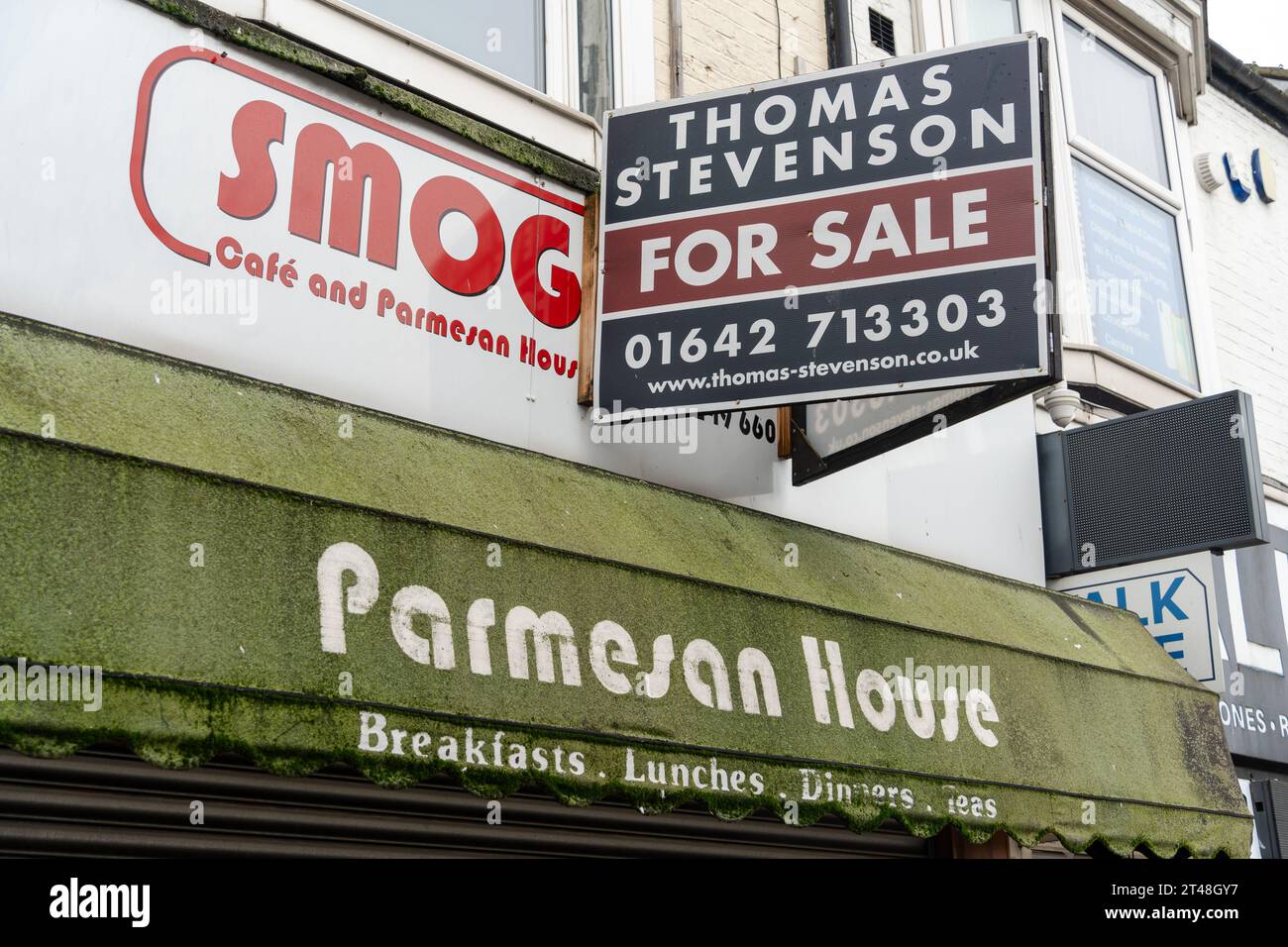 A closed down restaurant Smoggies Parmesan House in Middlesbrough, UK has green moss growing on its canopy. Concept of the death of the high street Stock Photo