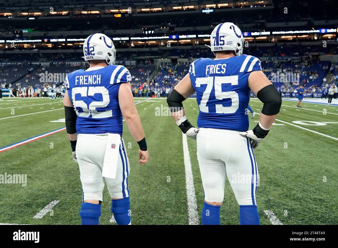 Indianapolis Colts center Wesley French (62) and Indianapolis Colts guard Will Fries (75) watch during warmups before an NFL football game against the New Orleans Saints, Sunday, Oct. 29, 2023 in Indianapolis. (