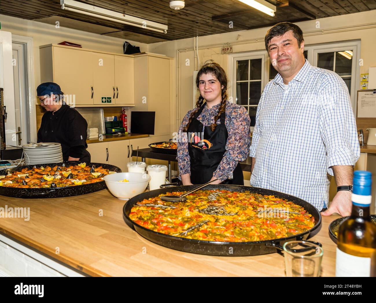"Paella Bob" serves a meal to the Volunters of the Otterton Community Shop. Stock Photo
