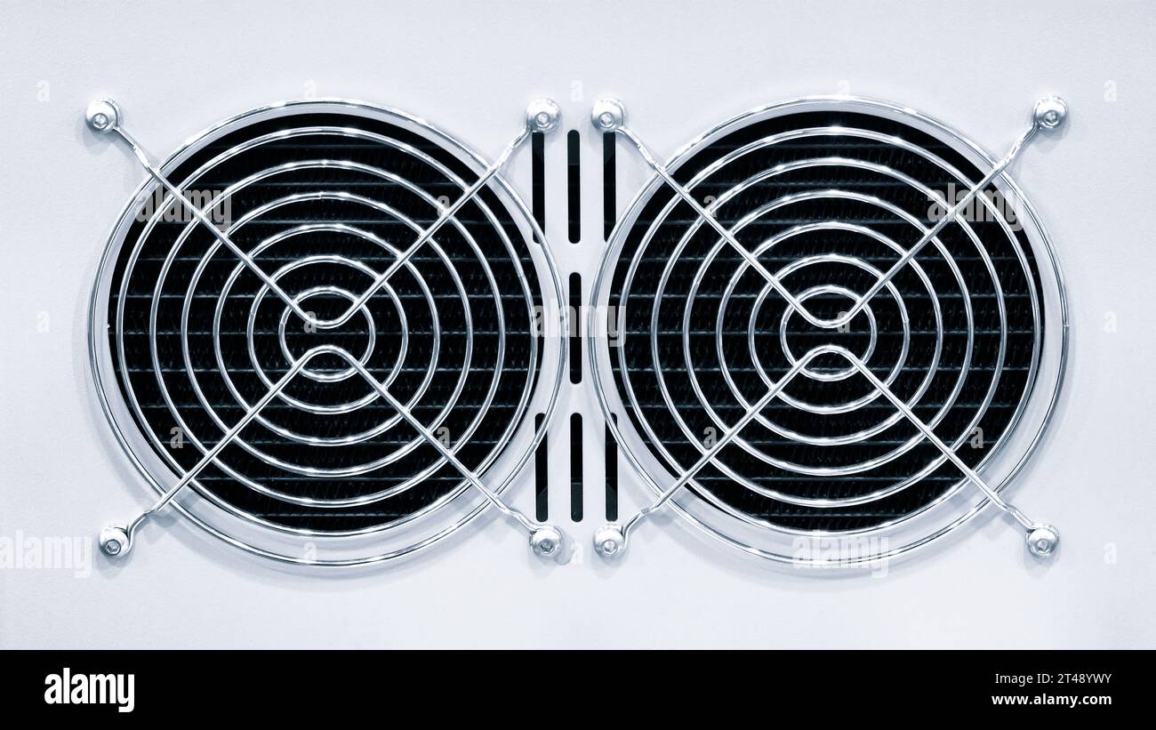 An air fan behind a metal grille installed on a modern computer AC