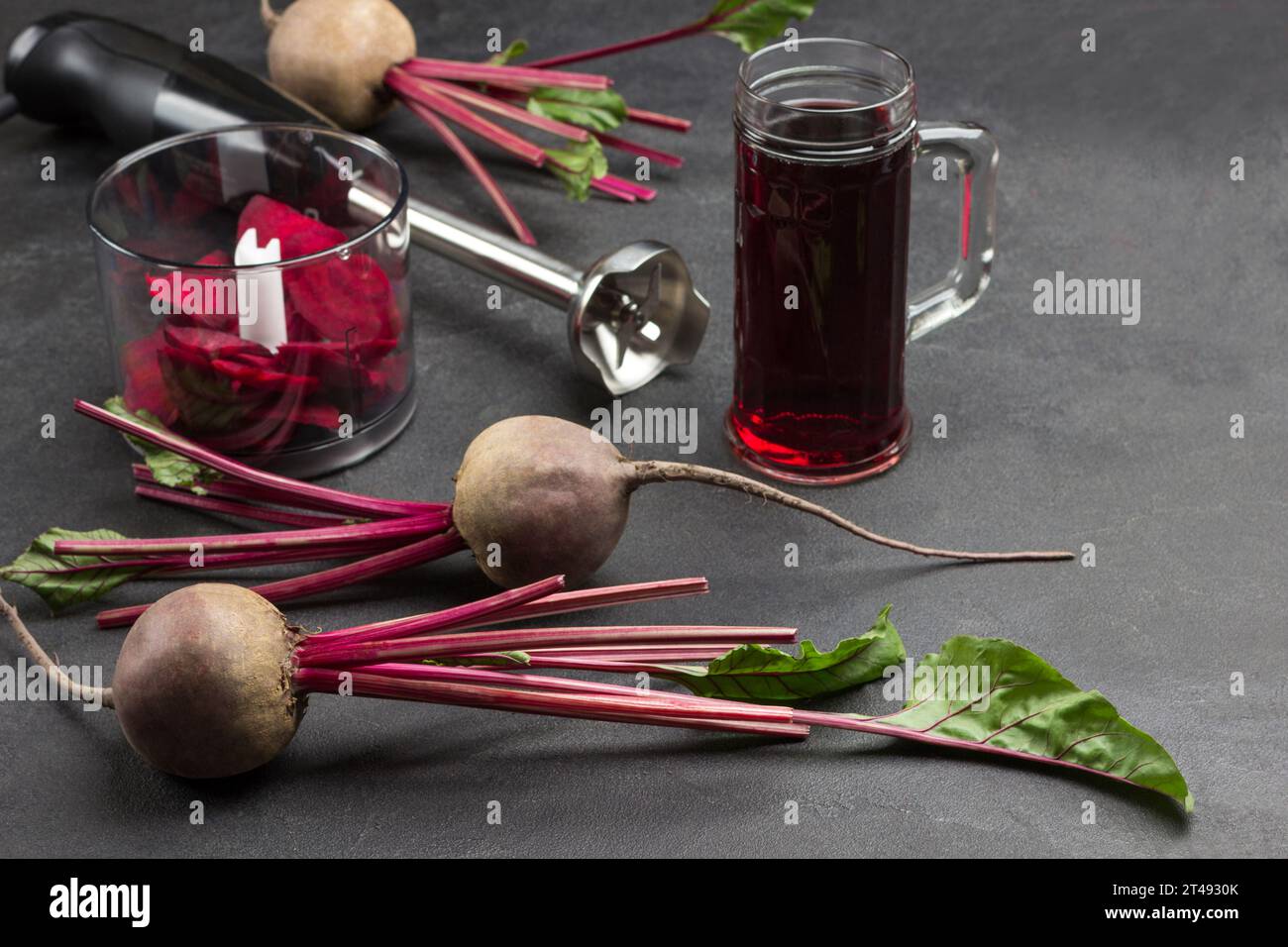 Beets with tops, sliced beets. Glass of beetroot juice. Sliced beet in