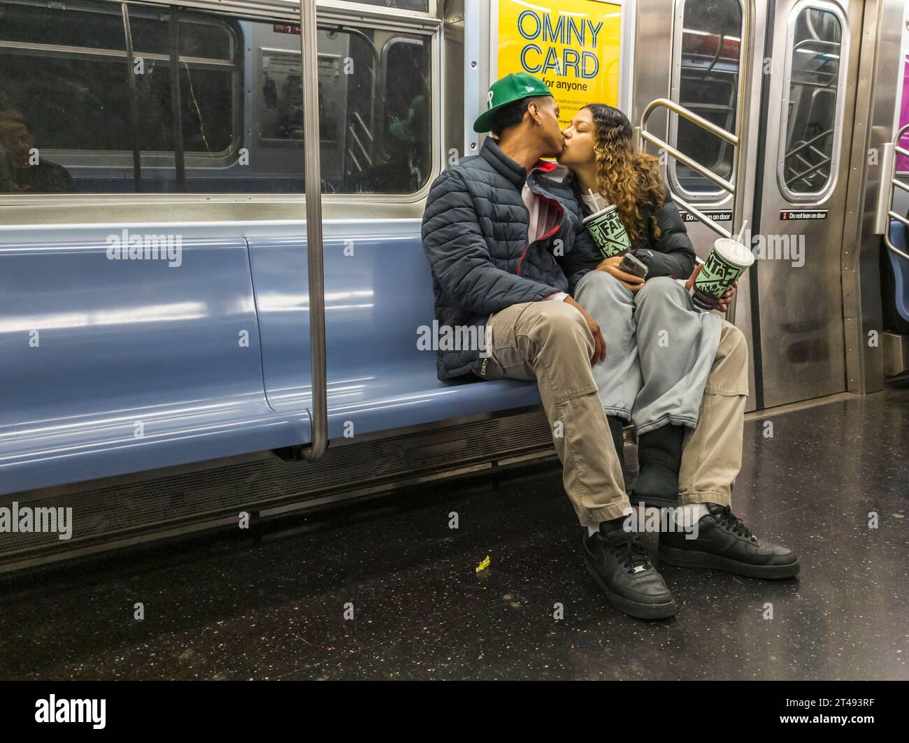 Public display of affection on the E train in the New York subway on Wednesday, October 25, 2023. (© Richard B. Levine) Stock Photo