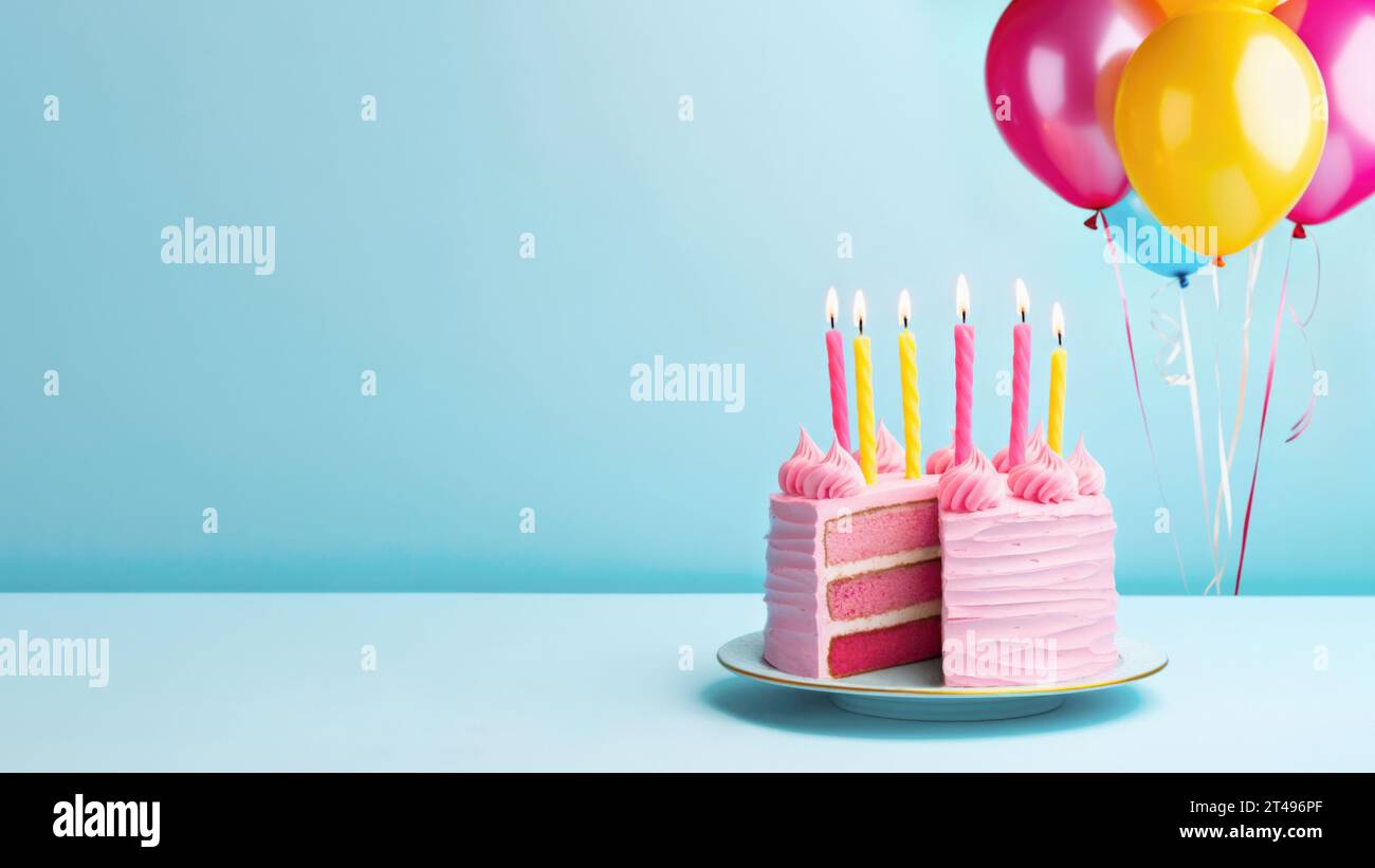 Pink birthday cake with birthday candles and pink and yellow party balloons against a blue background Stock Photo