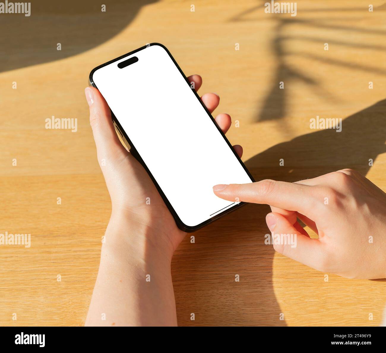 Berlin, Germany October 20 2023 Finger clicking, tapping on mobile phone mock up, smartphone screen mockup closeup Stock Photo