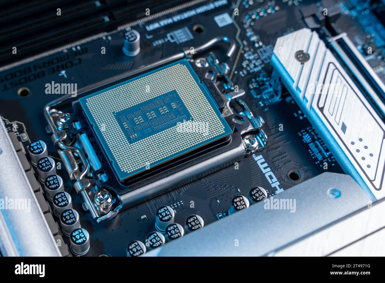 the processor in the motherboard socket is a close-up. modern powerful and fast motherboard with slots for RAM and CPU. the concept of PC hardware. Stock Photo
