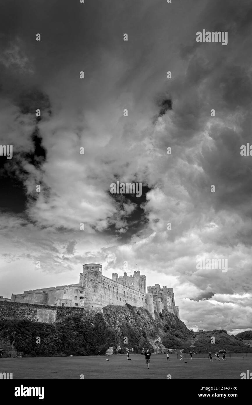 Monochrome image of Bamburgh Castle with a dramatic sky, Bamburgh, Northumberland, England, UK Stock Photo