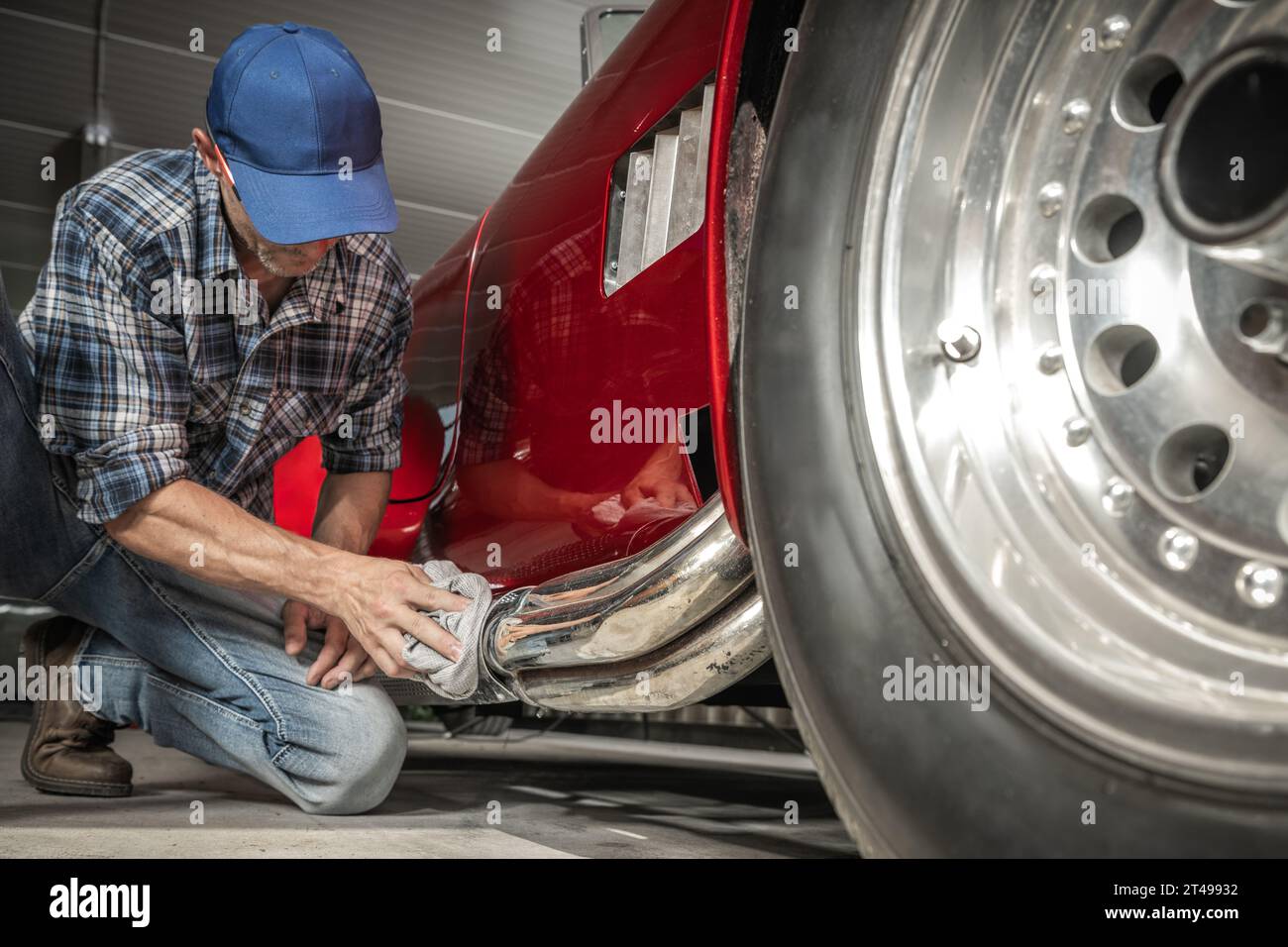 Classic Cars Mechanic Cleaning Part of American Muscle Car Muffler