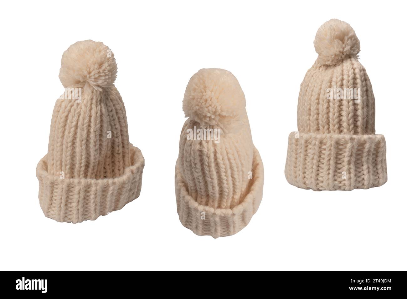 Beige warm beanie hat with pom pom isolated on a white background. Stock Photo