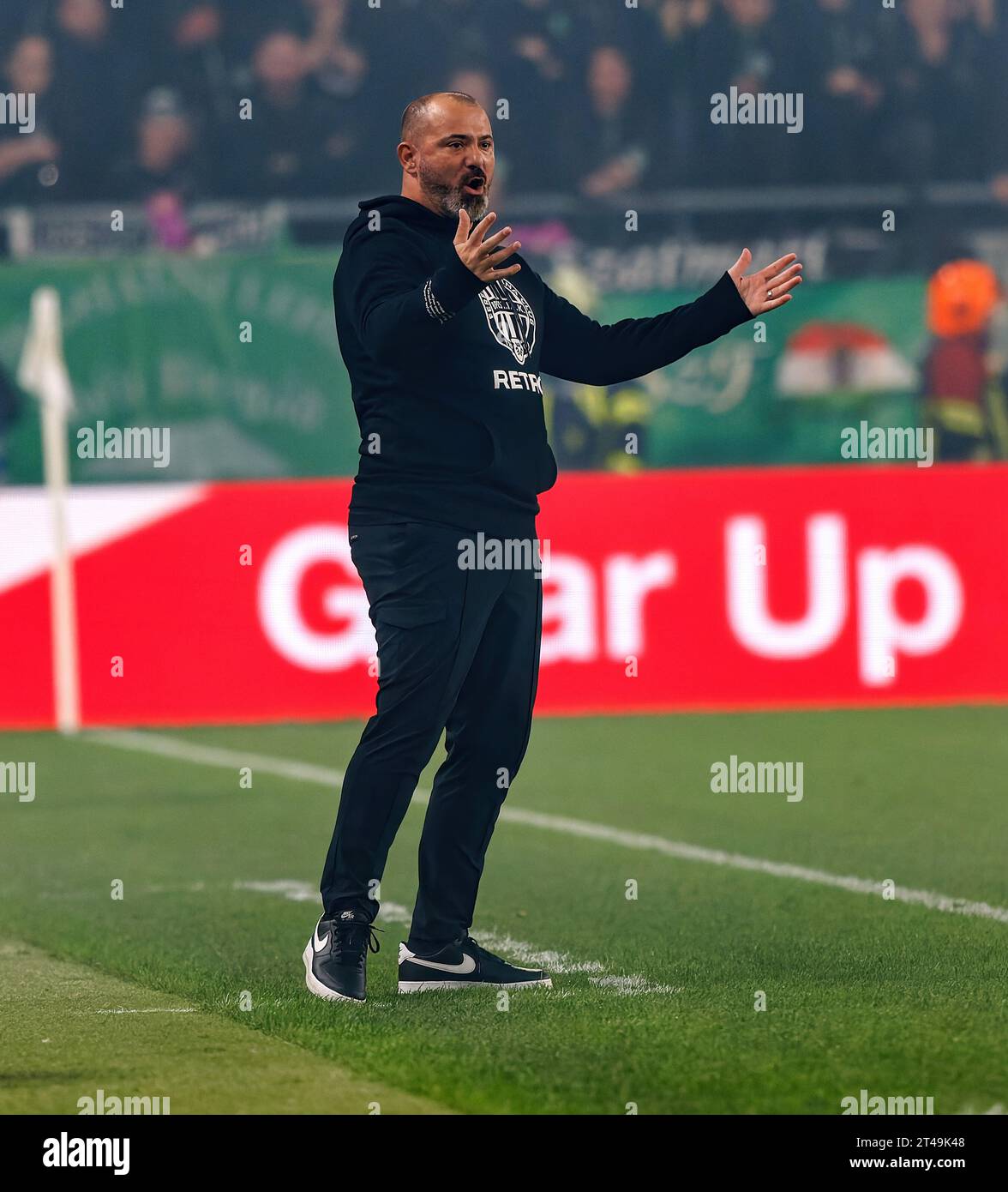 Ultra supporters of Ferencvarosi TC lift scarves over their heads